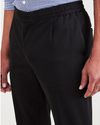View of model wearing Beautiful Black Men's Slim Tapered Fit Refined Pull-On Pants.