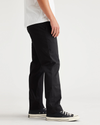 Side view of model wearing Beautiful Black Original Chino, Slim Fit.