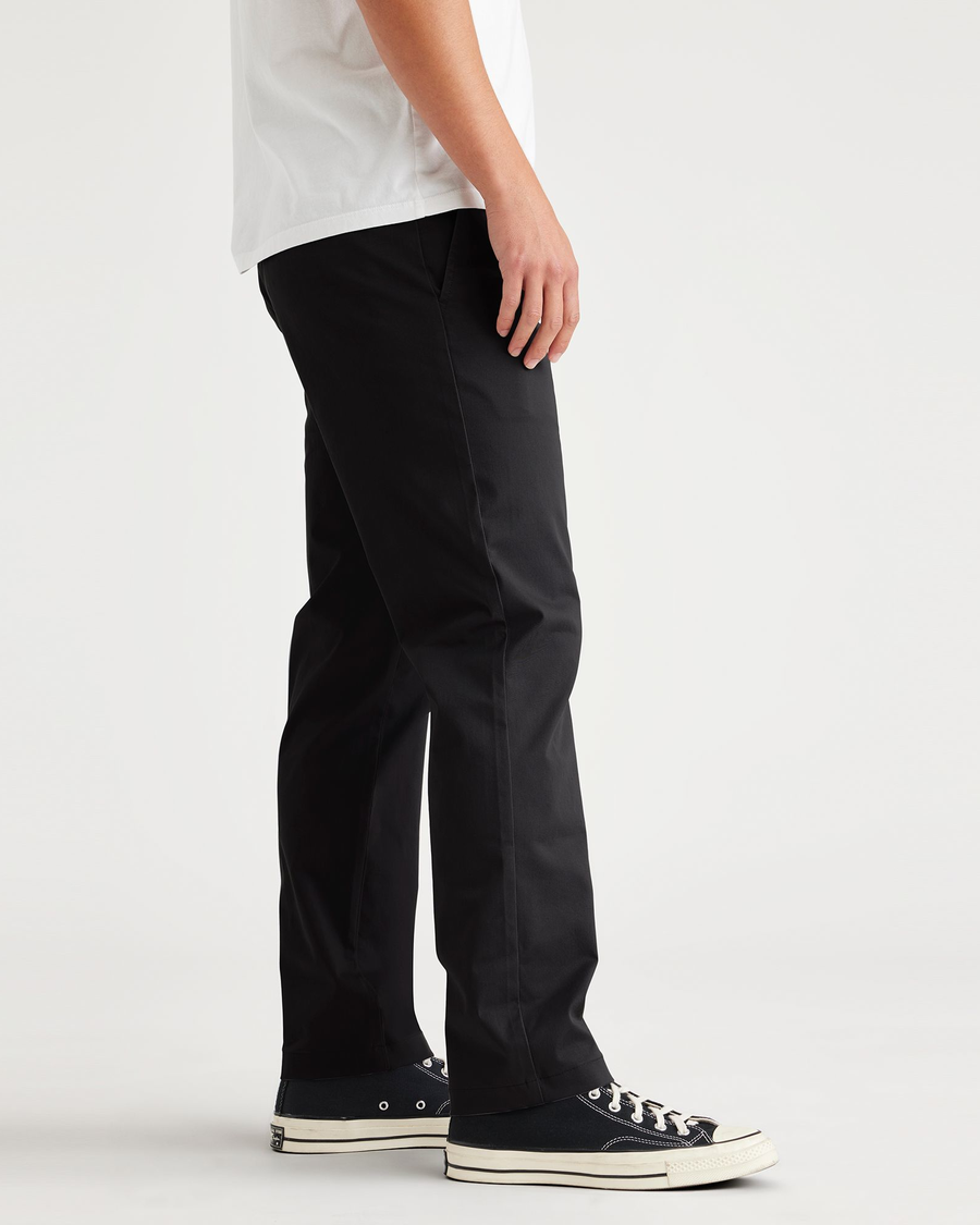 Side view of model wearing Beautiful Black Original Chino, Slim Fit.