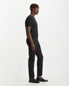 Side view of model wearing Black Crafted Khaki Pants, Slim Tapered Fit.