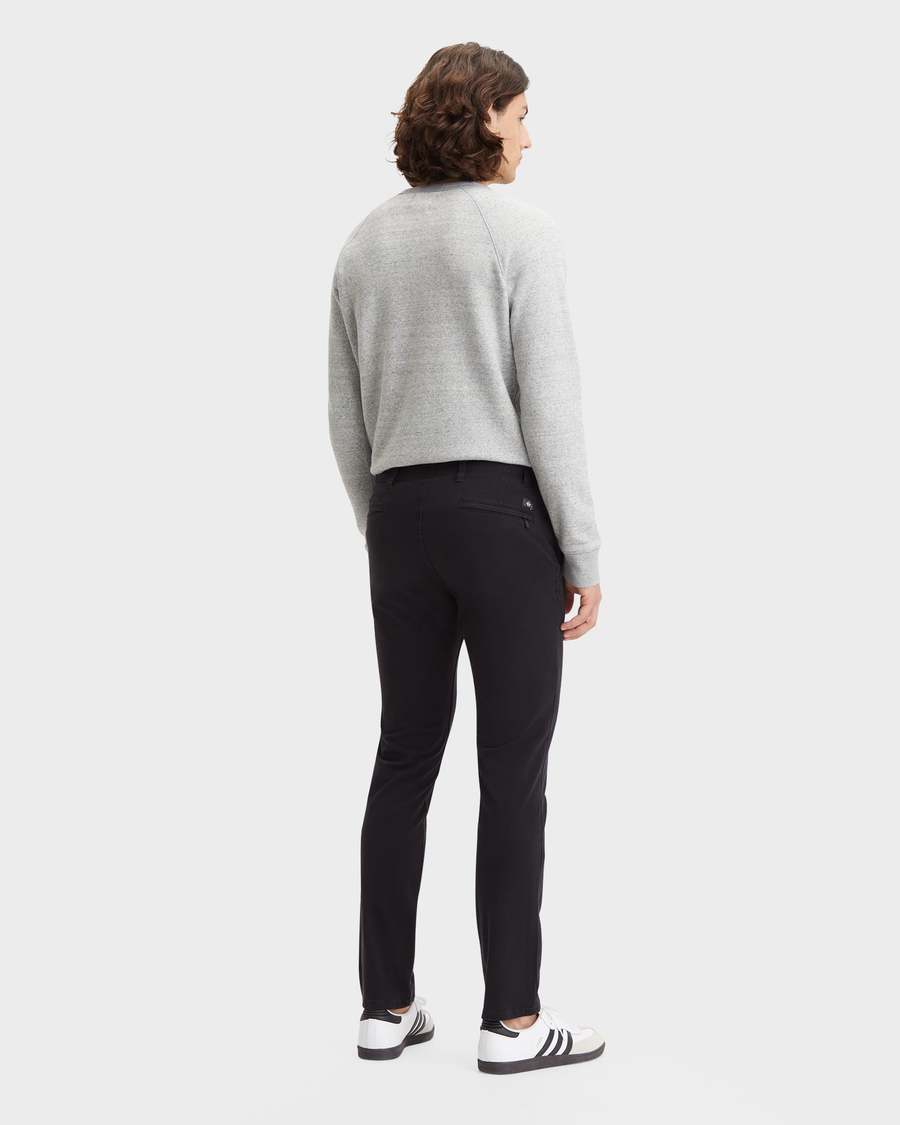 Back view of model wearing Black Men's Skinny Fit Smart 360 Flex Alpha Khaki Pants.