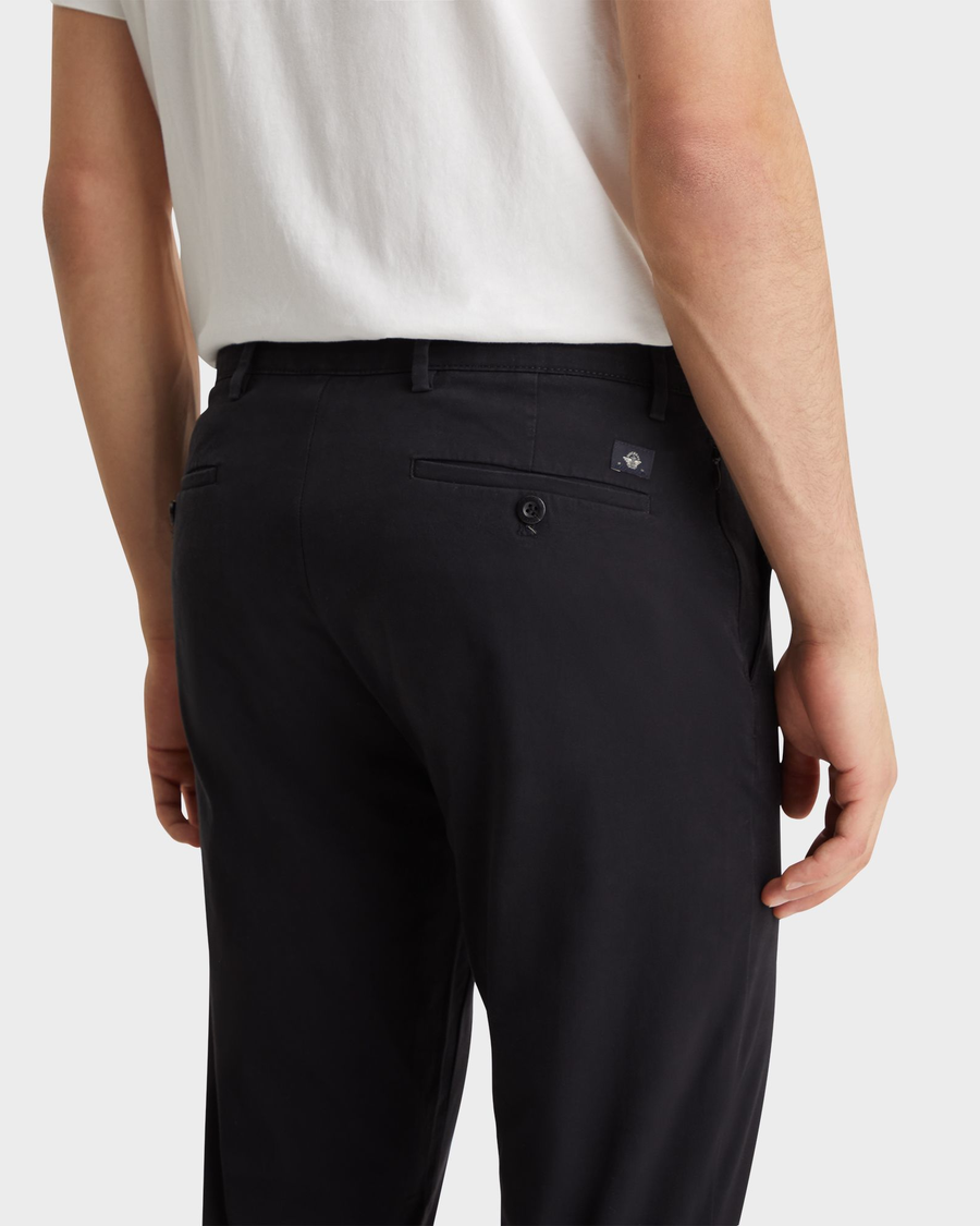 View of model wearing Black Men's Slim Fit Smart 360 Flex Alpha Chino Pants.