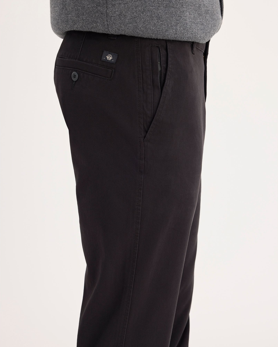 Side view of model wearing Black Ultimate Chinos, Slim Fit.