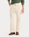 Front view of model wearing Buttercream Eighty-Six Original Pleated Chinos, Loose Fit.