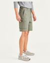 Side view of model wearing Camo Men's Straight Fit Supreme Flex Cargo Shorts.