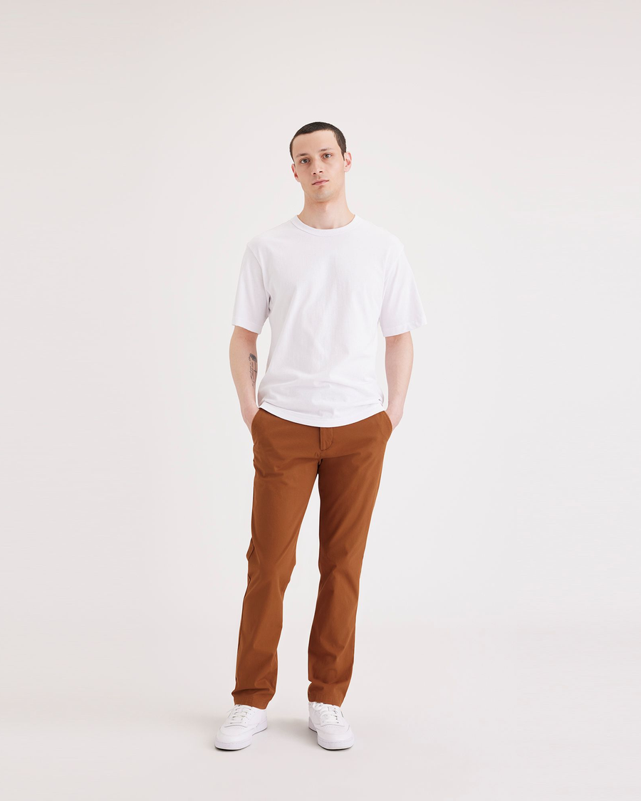 Front view of model wearing Caramel Café Men's Slim Fit Smart 360 Flex Alpha Chino Pants.