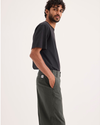 Side view of model wearing Chimera Eighty-Six Alpha Chino Pants, Loose Fit.