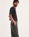 Side view of model wearing Chimera Eighty-Six Alpha Chino Pants, Loose Fit.