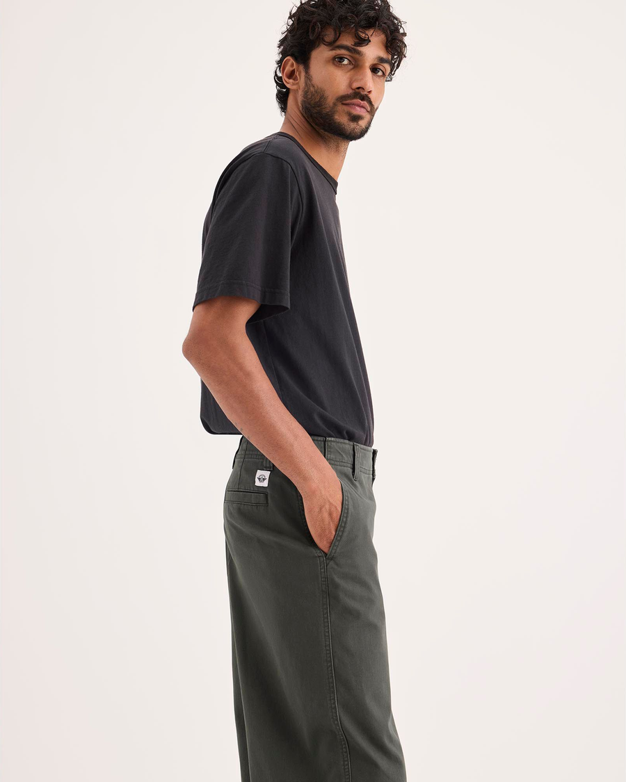 Side view of model wearing Chimera Eighty-Six Alpha Chino Pants, Loose Fit.