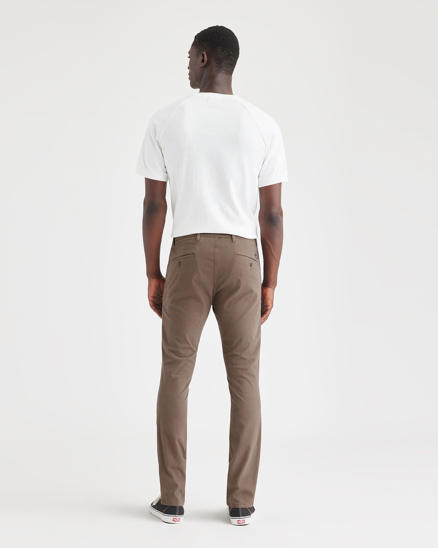 Back view of model wearing Coffee Quartz Men's Skinny Fit Supreme Flex Alpha Khaki Pants.