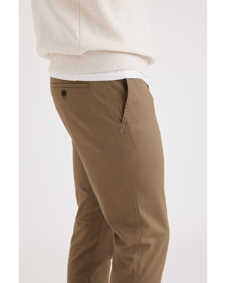 Side view of model wearing Cub Men's Skinny Fit Original Chino Pants.