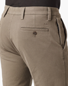 View of model wearing Dark Pebble Men's Slim Fit Smart 360 Flex Workday Khaki Pants.