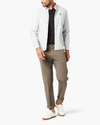 Front view of model wearing Dark Pebble Men's Slim Fit Smart 360 Flex Workday Khaki Pants.