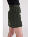 Side view of model wearing Deep Forest Women's Button Front Mini Skirt.