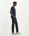 Side view of model wearing Dockers Navy Crafted Khaki Pants, Slim Tapered Fit.