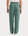 Back view of model wearing Duck Green Eighty-Six Original Chino Pants, Loose Fit.