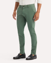 Side view of model wearing Duck Green Ultimate Chinos, Skinny Fit.