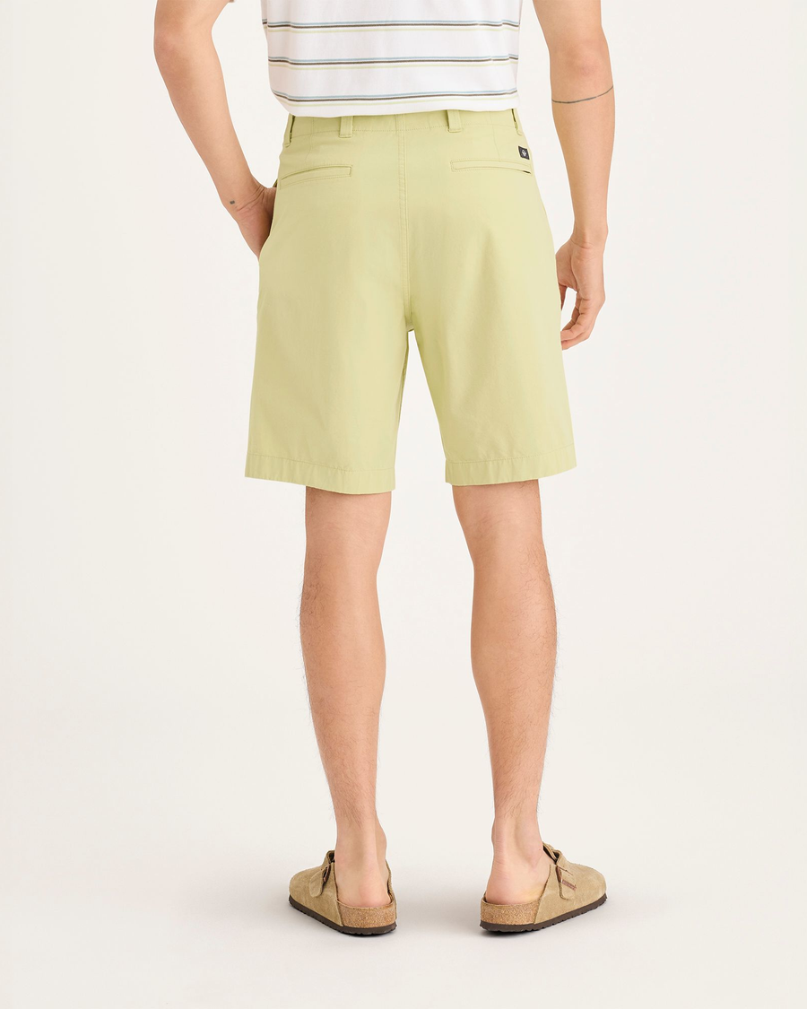Back view of model wearing Dusty Yellow Alpha Chino Shorts, Straight Fit.