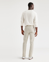 Back view of model wearing Grit Men's Slim Fit Smart 360 Flex Alpha Chino Pants.