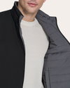 View of model wearing Grit Reversible Puffer Vest.