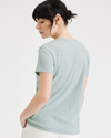 Back view of model wearing Harbor Gray Women's Slim Fit Graphic Tee Shirt.