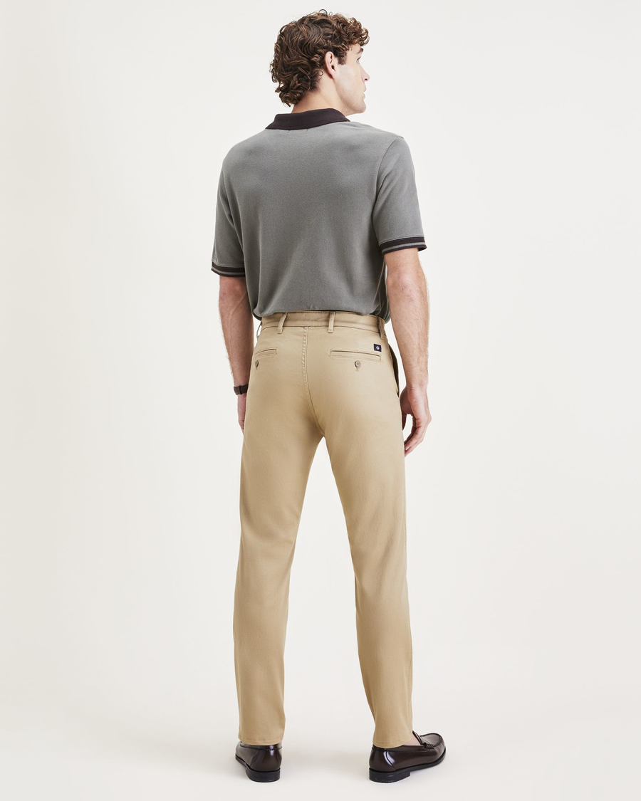 Back view of model wearing Harvest Gold Men's Slim Fit Original Chino Pants.