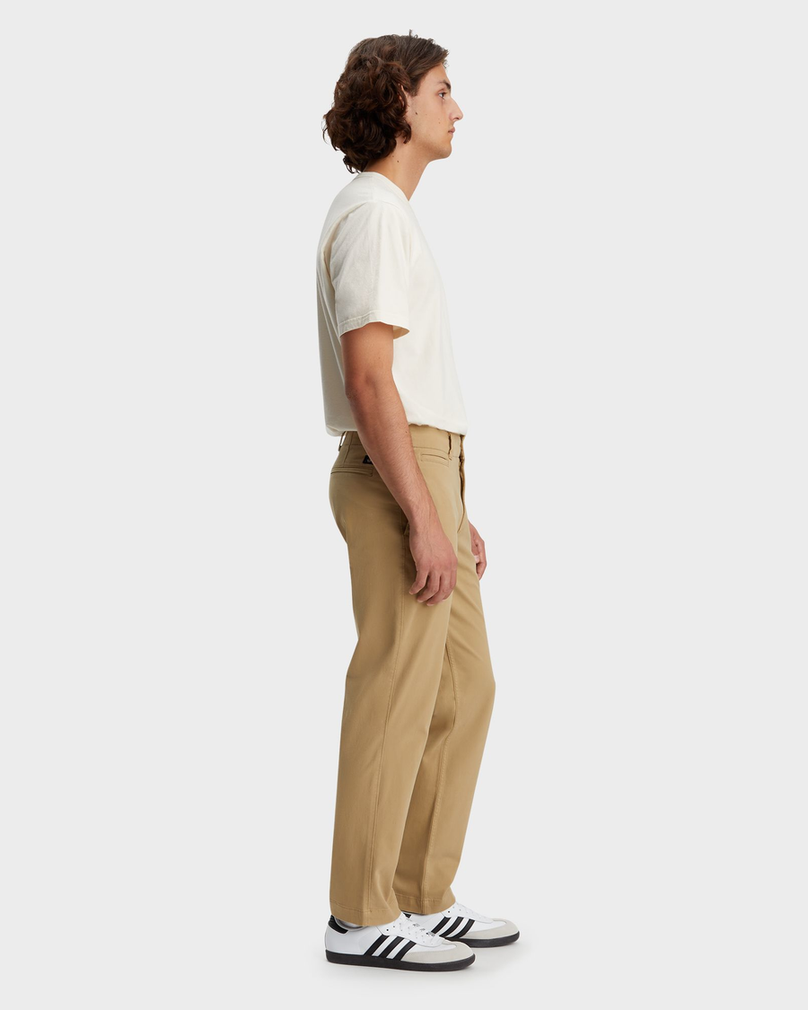 Side view of model wearing Harvest Gold Men's Straight Fit Smart 360 Flex California Chino Pants.