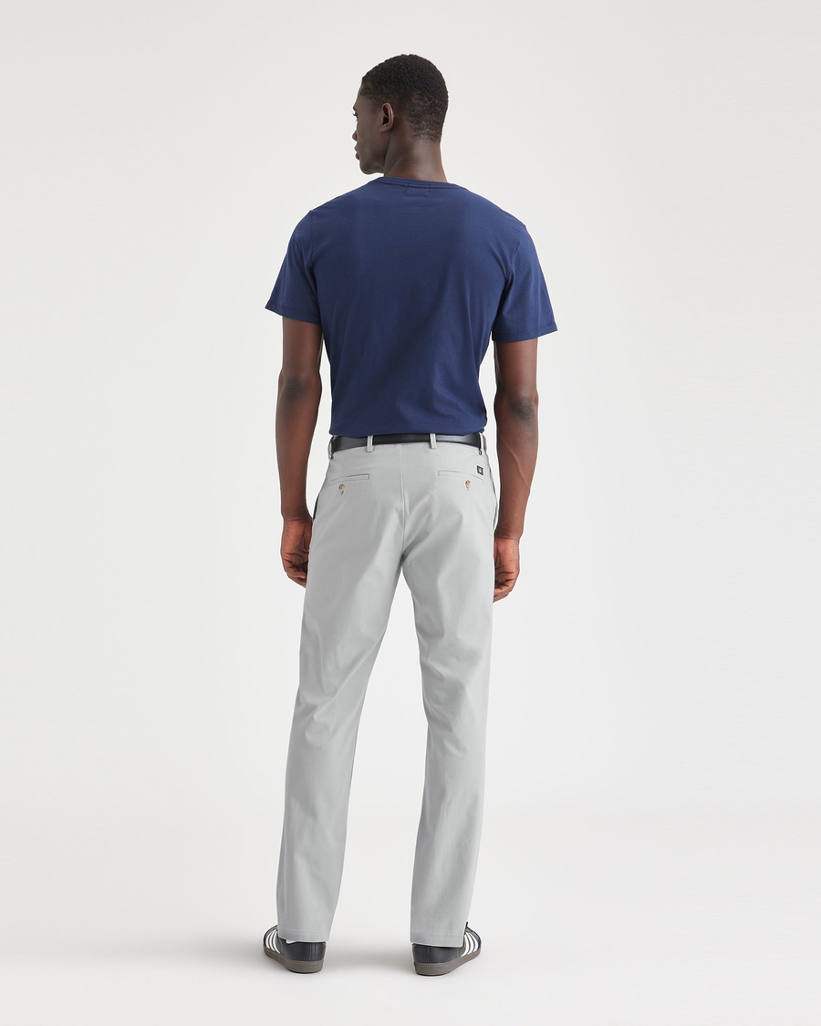 Back view of model wearing High-Rise Men's Slim Fit Smart 360 Flex Alpha Chino Pants.