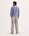Back view of model wearing Ichabod Buttercream Eighty-Six Utility Pants, Loose Fit.