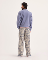 Back view of model wearing Ichabod Buttercream Eighty-Six Utility Pants, Loose Fit.