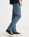 Side view of model wearing Indian Teal Men's Slim Fit Smart 360 Flex Alpha Chino Pants.