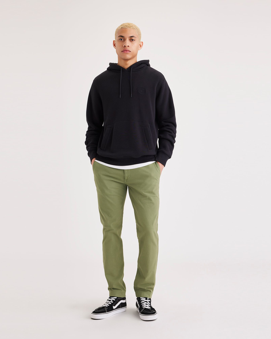 Front view of model wearing Loden Green Men's Skinny Fit Smart 360 Flex California Chino Pants.