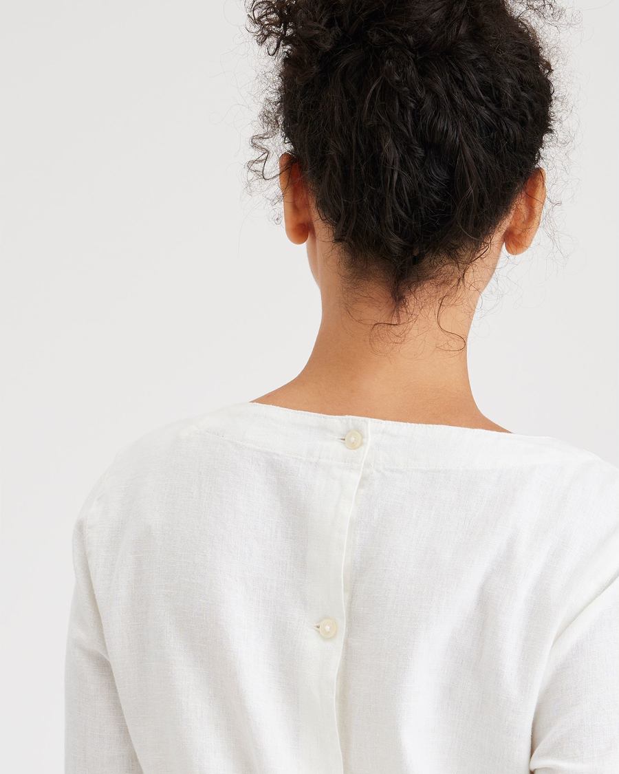 View of model wearing Lucent White Women's Button Back Blouse.