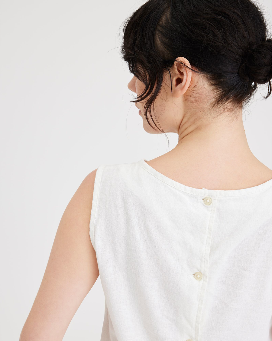 View of model wearing Lucent White Women's Button Back Tank.