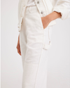 View of model wearing Lucent White Women's Straight Fit Carpenter Pants.