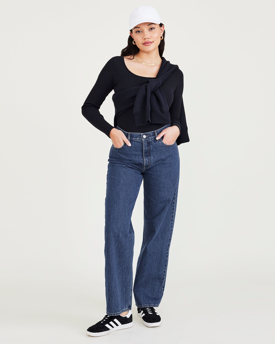 View of model wearing Medium Indigo Stonewash Women's Relaxed Fit Mid-Rise Jeans.