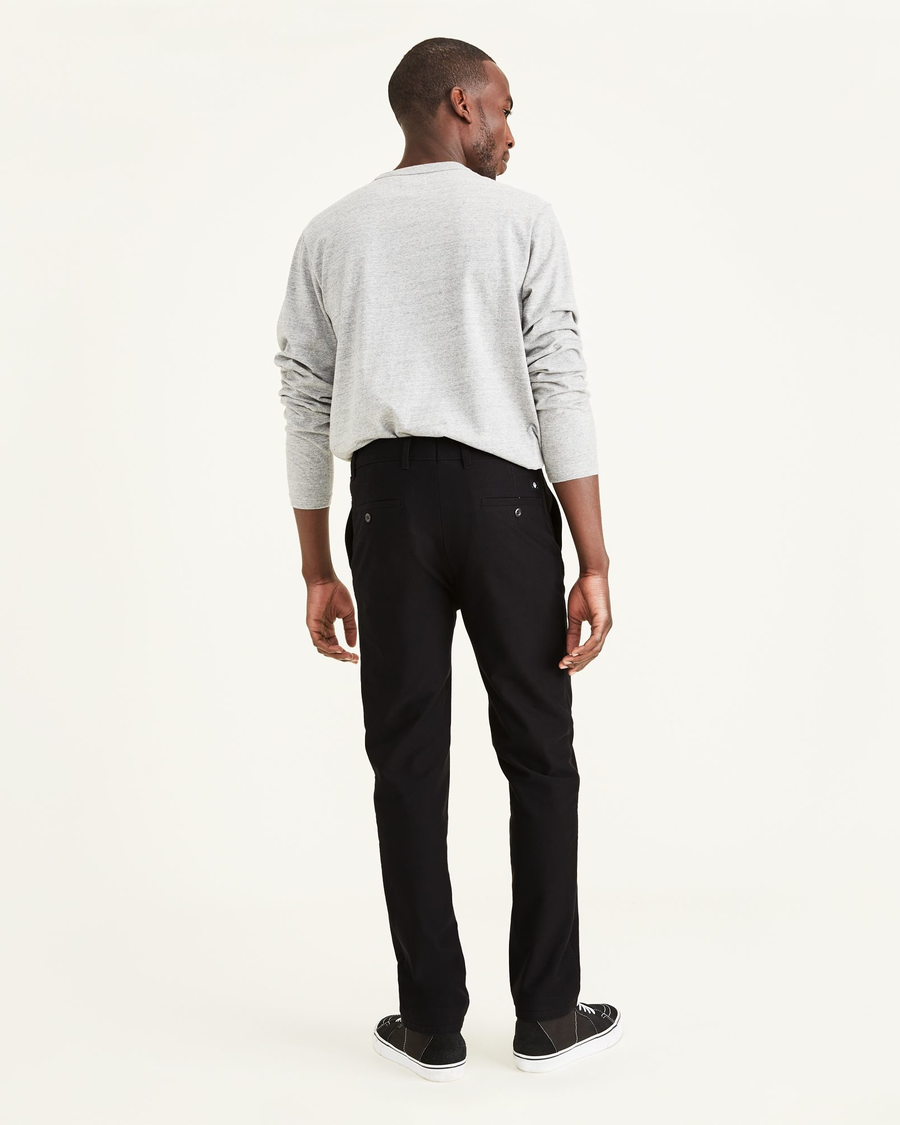 Back view of model wearing Mineral Black Smart 360 Flex Comfort Knit Chino Pants, Slim Fit.