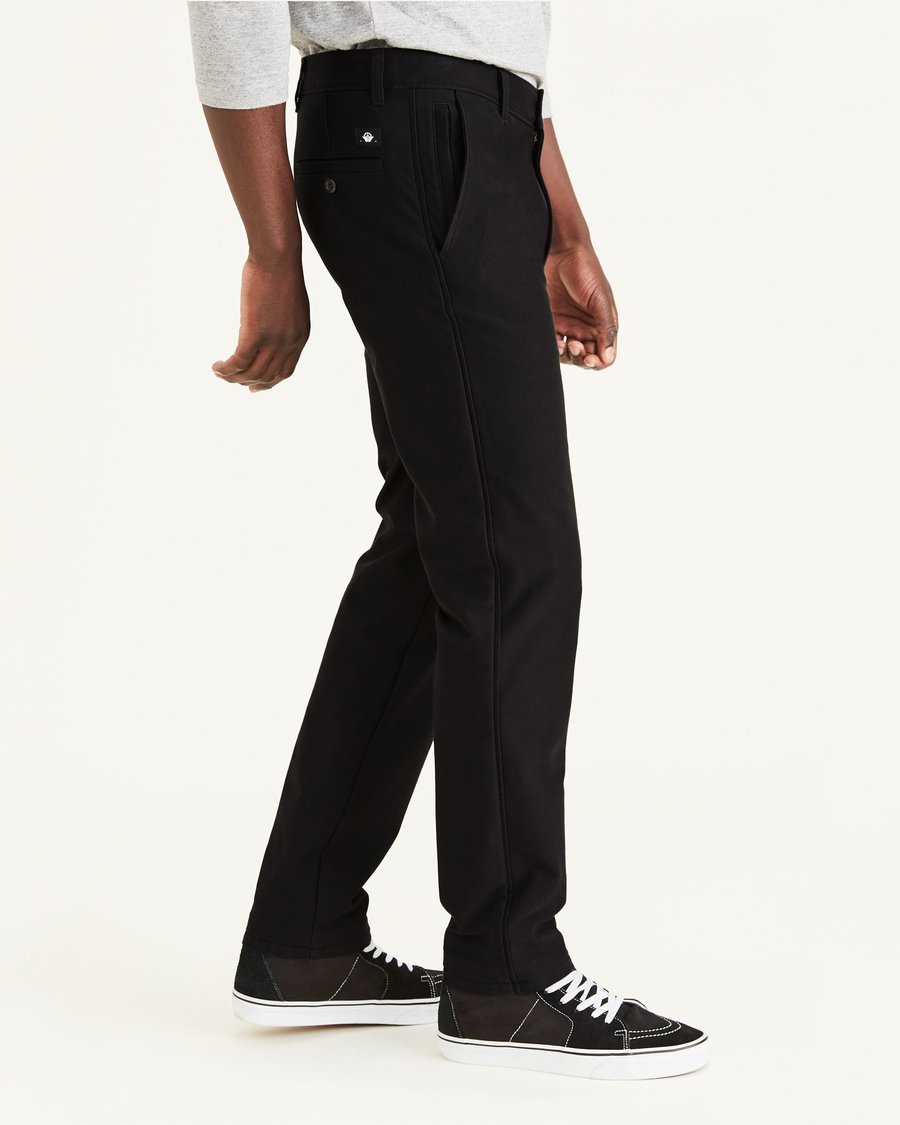 Side view of model wearing Mineral Black Smart 360 Flex Comfort Knit Chino Pants, Slim Fit.