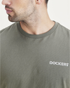View of model wearing Mottled Green Men's Slim Fit Logo Tee.