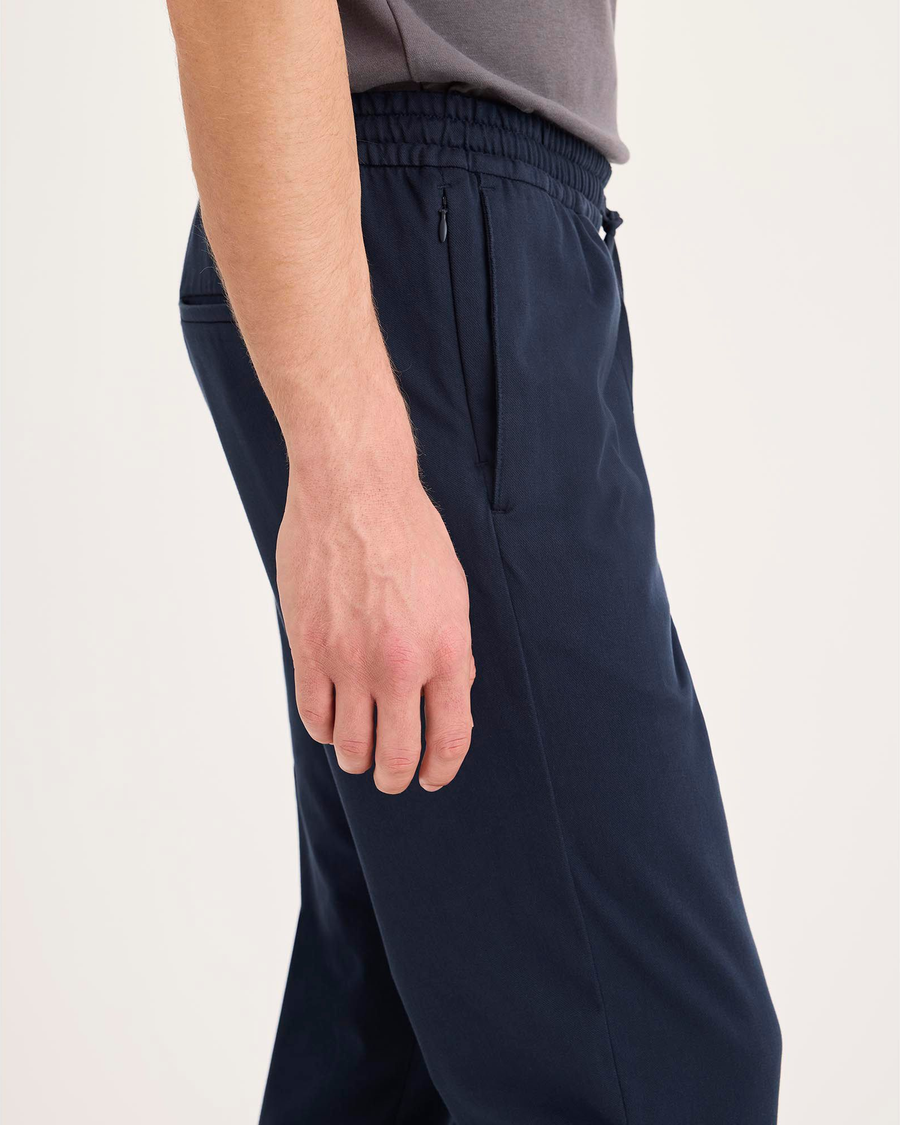 Side view of model wearing Navy Blazer Go Activeflex Pull-On Pant, Slim Fit.
