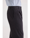 Side view of model wearing Navy Blazer Men's Loose Fit Pleated Original Chino Pants.