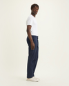 Side view of model wearing Navy Blazer Men's Slim Fit Supreme Flex Alpha Khaki Pants.