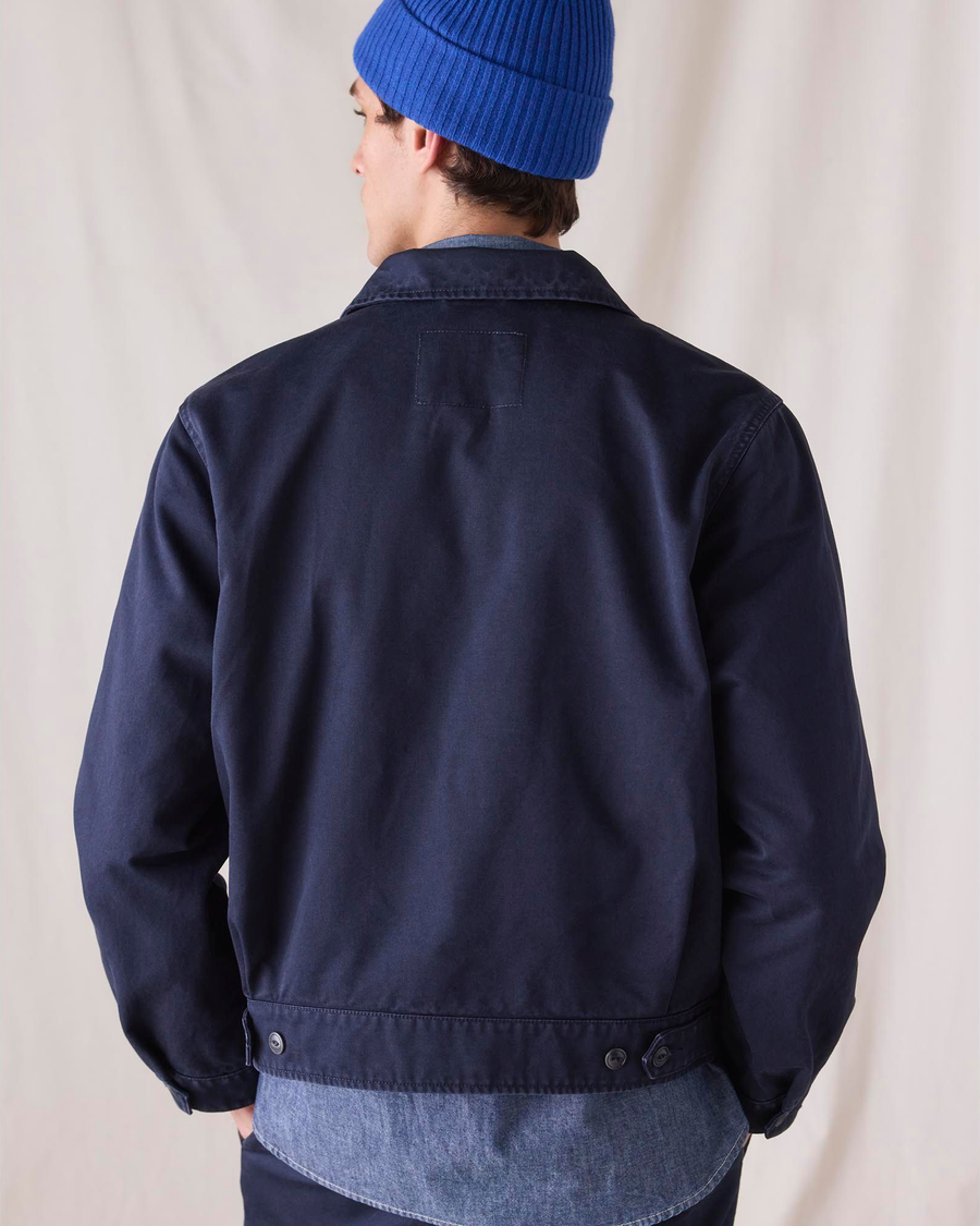 Back view of model wearing Navy Blue Dockers® x Transnomadica Mechanics Jacket.