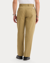 Back view of model wearing New British Khaki Eighty-Six Original Pleated Chinos, Loose Fit.