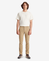 Front view of model wearing New British Khaki Men's Skinny Fit Smart 360 Flex Alpha Khaki Pants.