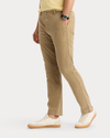 Side view of model wearing New British Khaki Original Chino Pants, Slim Fit.