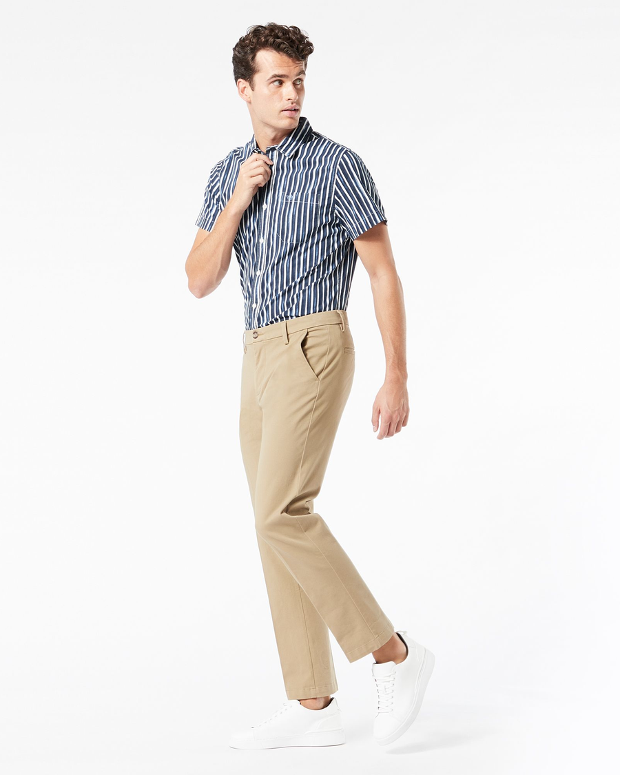 Side view of model wearing New British Khaki Workday Khaki Pants, Slim Fit.