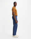 Side view of model wearing Ocean Blue Crafted Khaki Pants, Slim Fit.