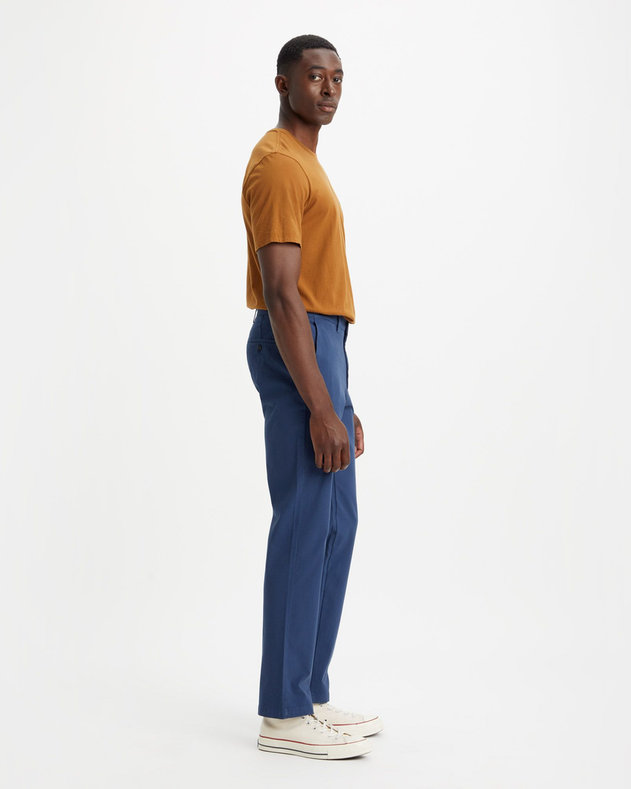 Side view of model wearing Ocean Blue Crafted Khaki Pants, Slim Fit.