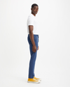 Side view of model wearing Ocean Blue Men's Skinny Fit Supreme Flex Alpha Khaki Pants.